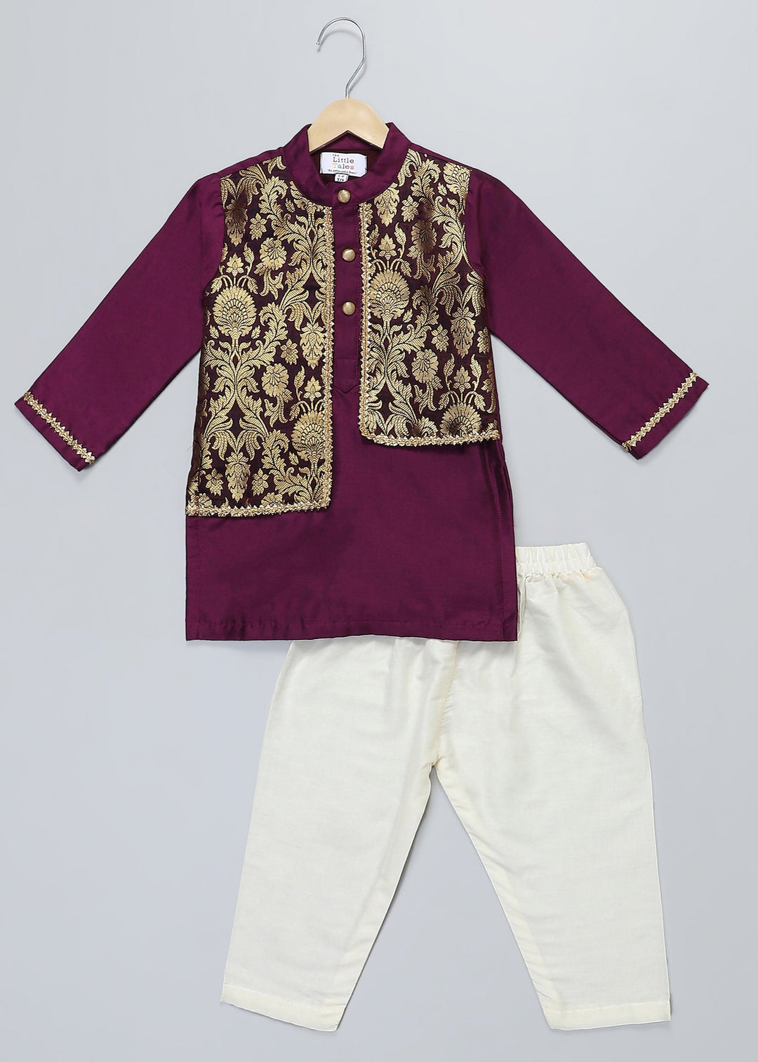 Traditional outfit with embroidered top and white pants on a gray background
