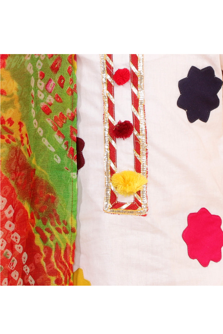 White kurta with colorful patches and dhoti with bandhani dupatta