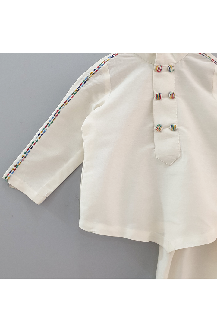 Ivory kurta pyjama with colorful thread detailing