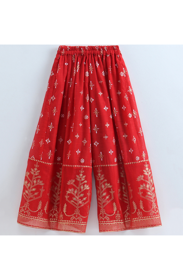 Green brocade halter neck top and red printed palazzo