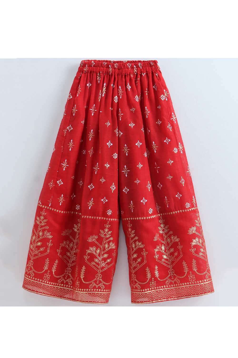 Green brocade halter neck top and red printed palazzo