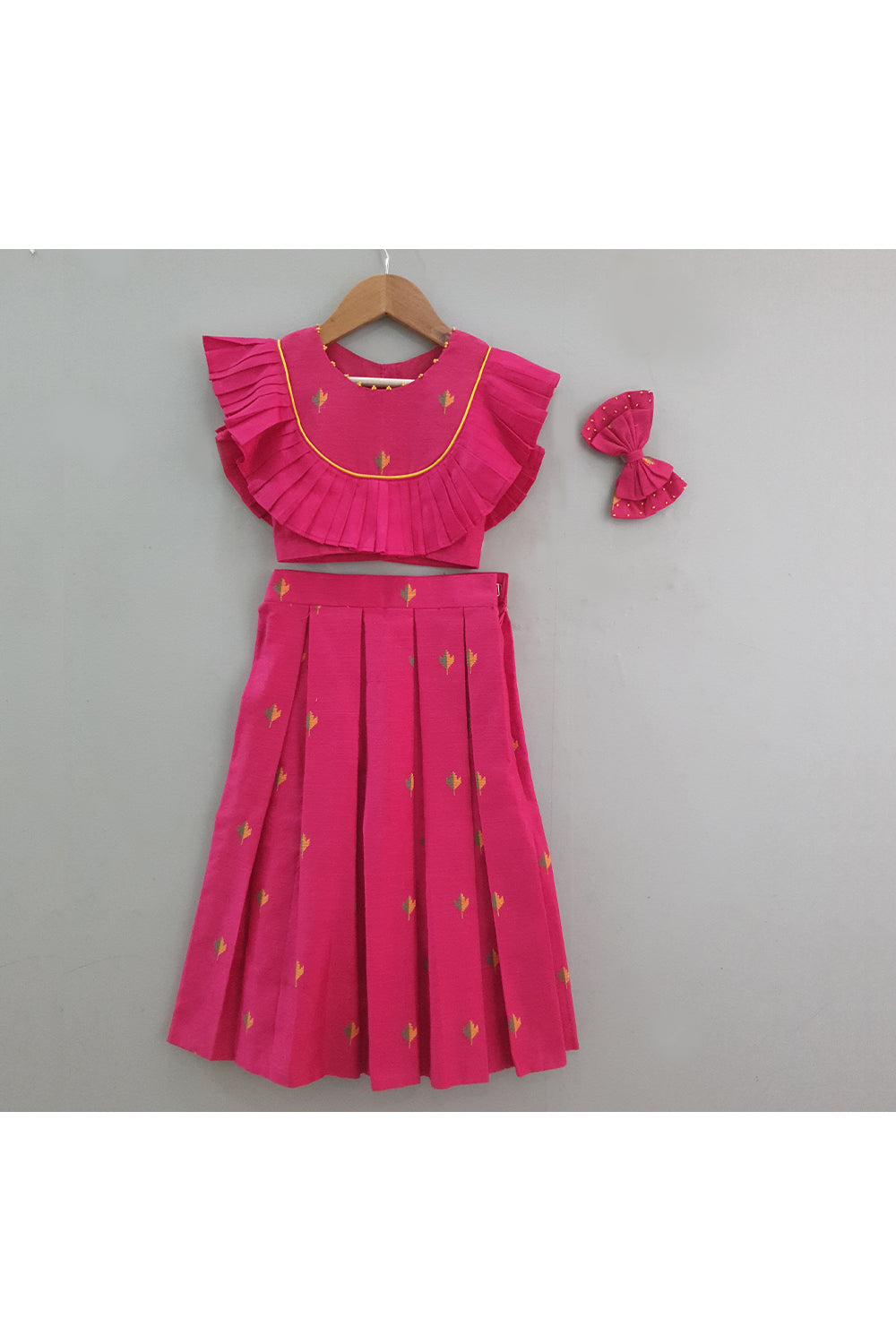 Magenta pink booti frill detailing top and pleated skirt with hair accessory
