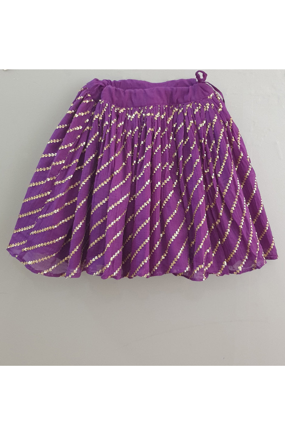 Red smocked tuck top with purple sequined ghagra