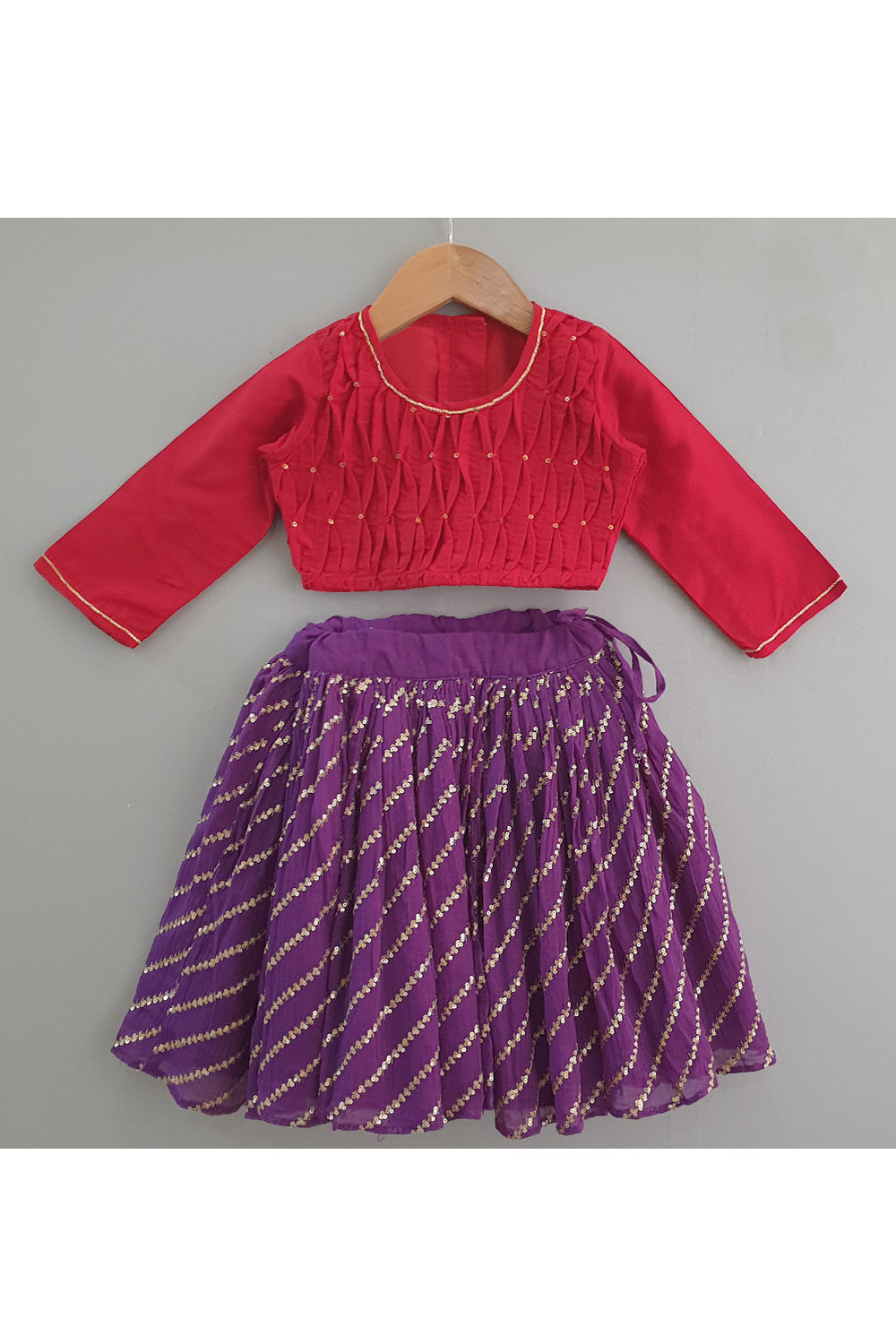 Red smocked tuck top with purple sequined ghagra
