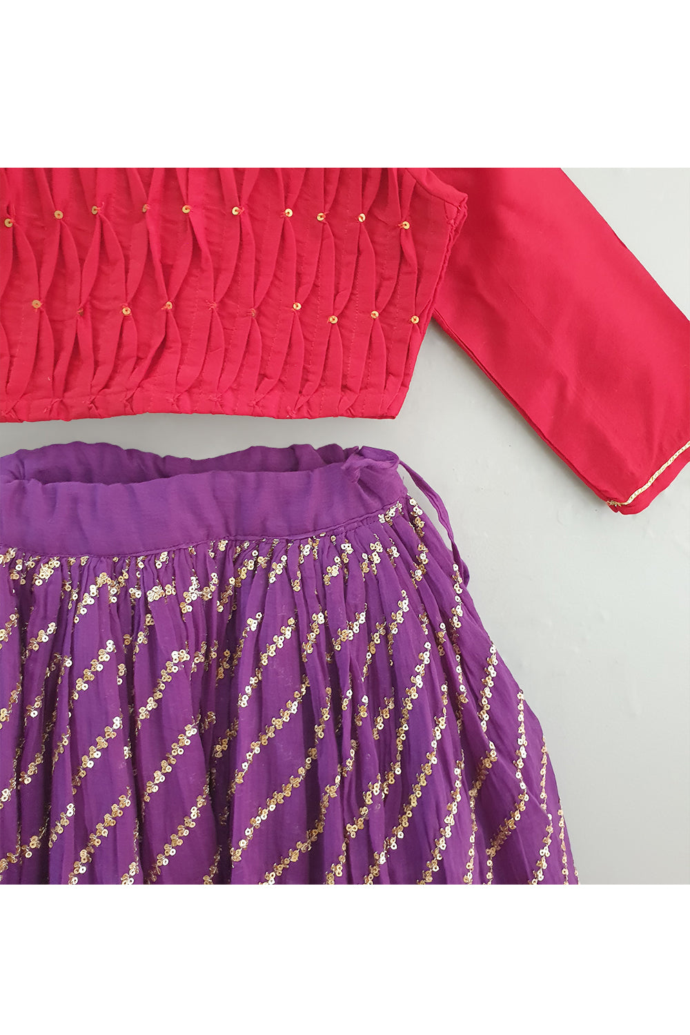 Red smocked tuck top with purple sequined ghagra