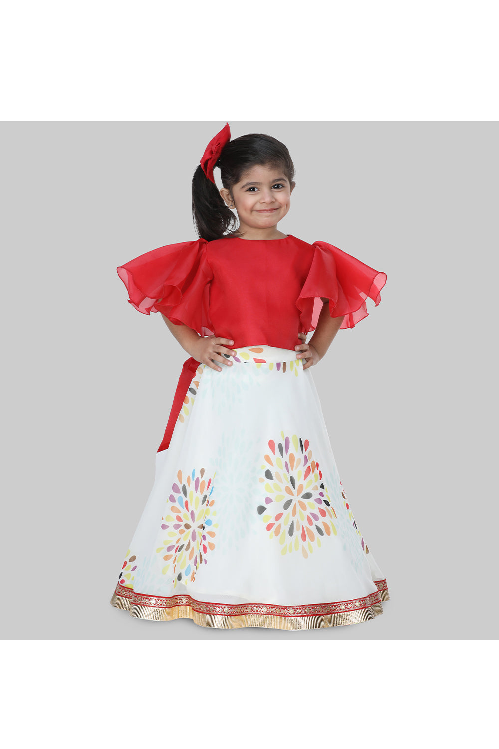 Red frilly sleeves top and printed lehenga with a sling bag