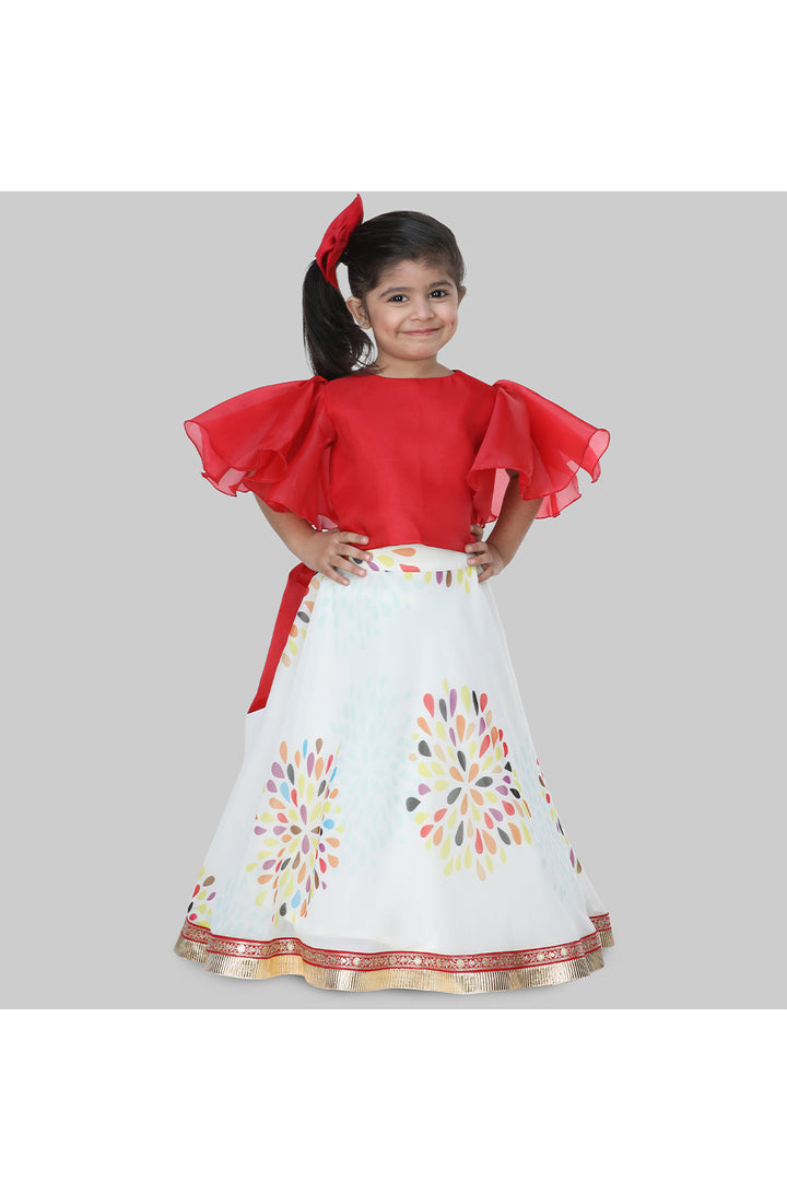 Red frilly sleeves top and printed lehenga with a sling bag