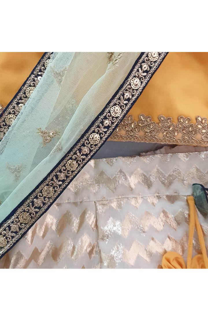 Yellow choli and off white lehenga with attached dupatta