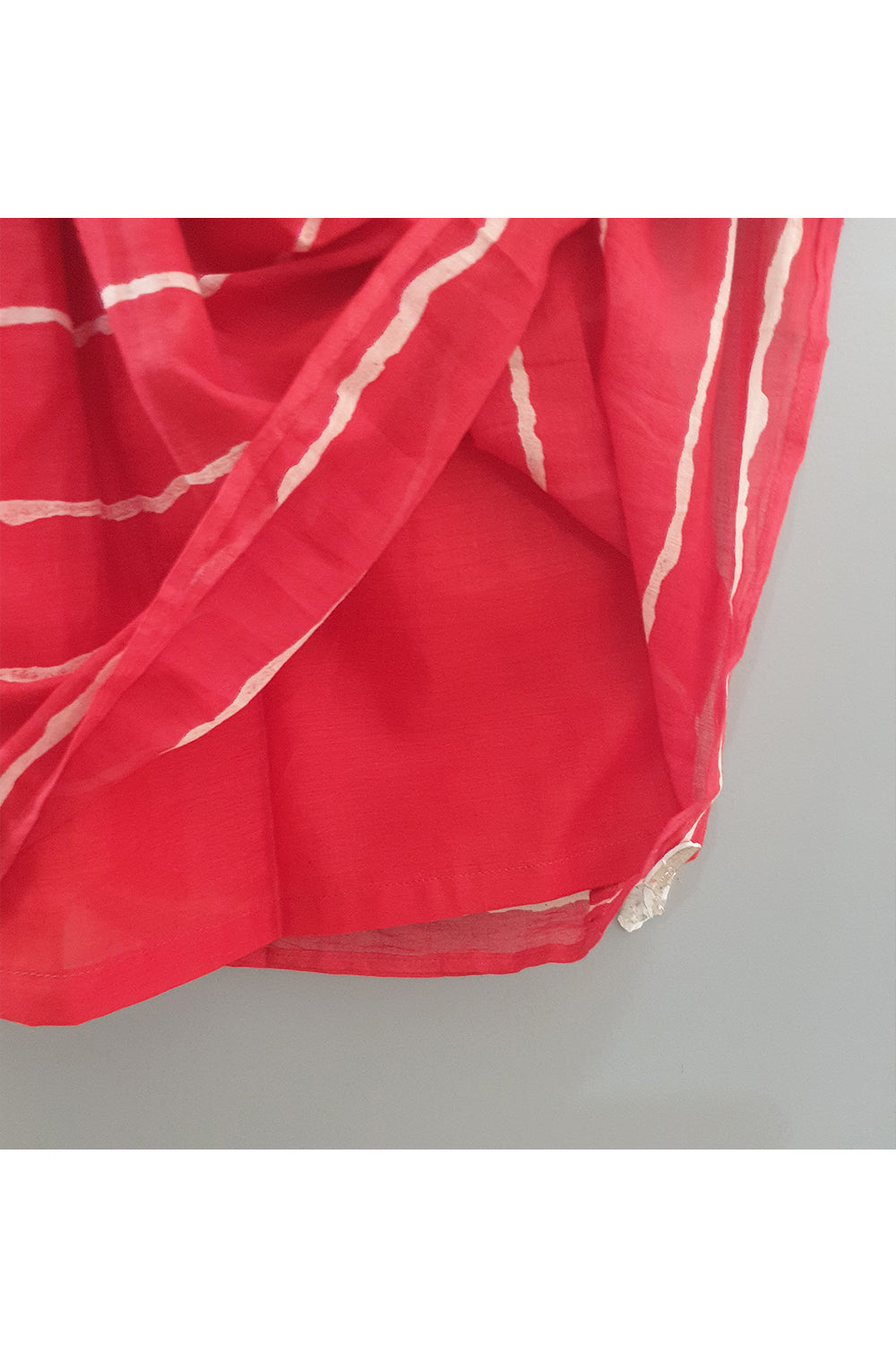 Off white embroidered top with red lehriya printed lehenga