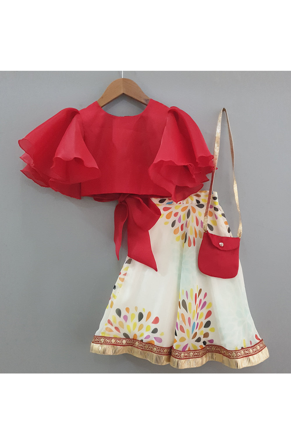Red frilly sleeves top and printed lehenga with a sling bag