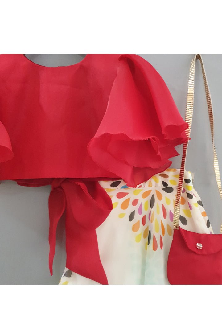 Red frilly sleeves top and printed lehenga with a sling bag